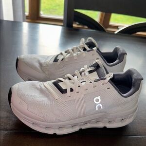 On Running White and Black Athletic Shoes with CloudTec Cushioning